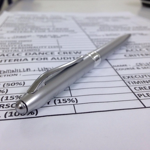 A close-up of a U.S. tax form (1040) with the section related to the Earned Income Tax Credit highlighted. A pen and calculator are placed next to the form, suggesting preparation and calculation.