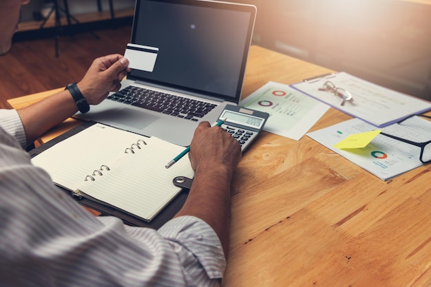 A person using a tax preparation software on a computer screen. The software displays fields for entering income and expenses related to the Earned Income Tax Credit.