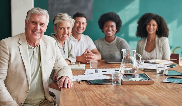 A diverse group of senior citizens participating in a financial planning seminar, with a presenter pointing to a slide about Social Security benefits and retirement strategies.